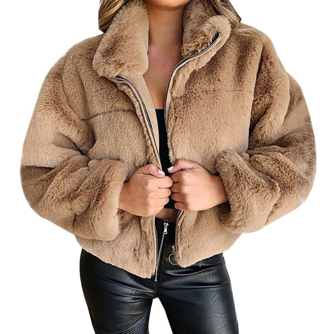 Beige faux fur jacket worn by a person on a white background